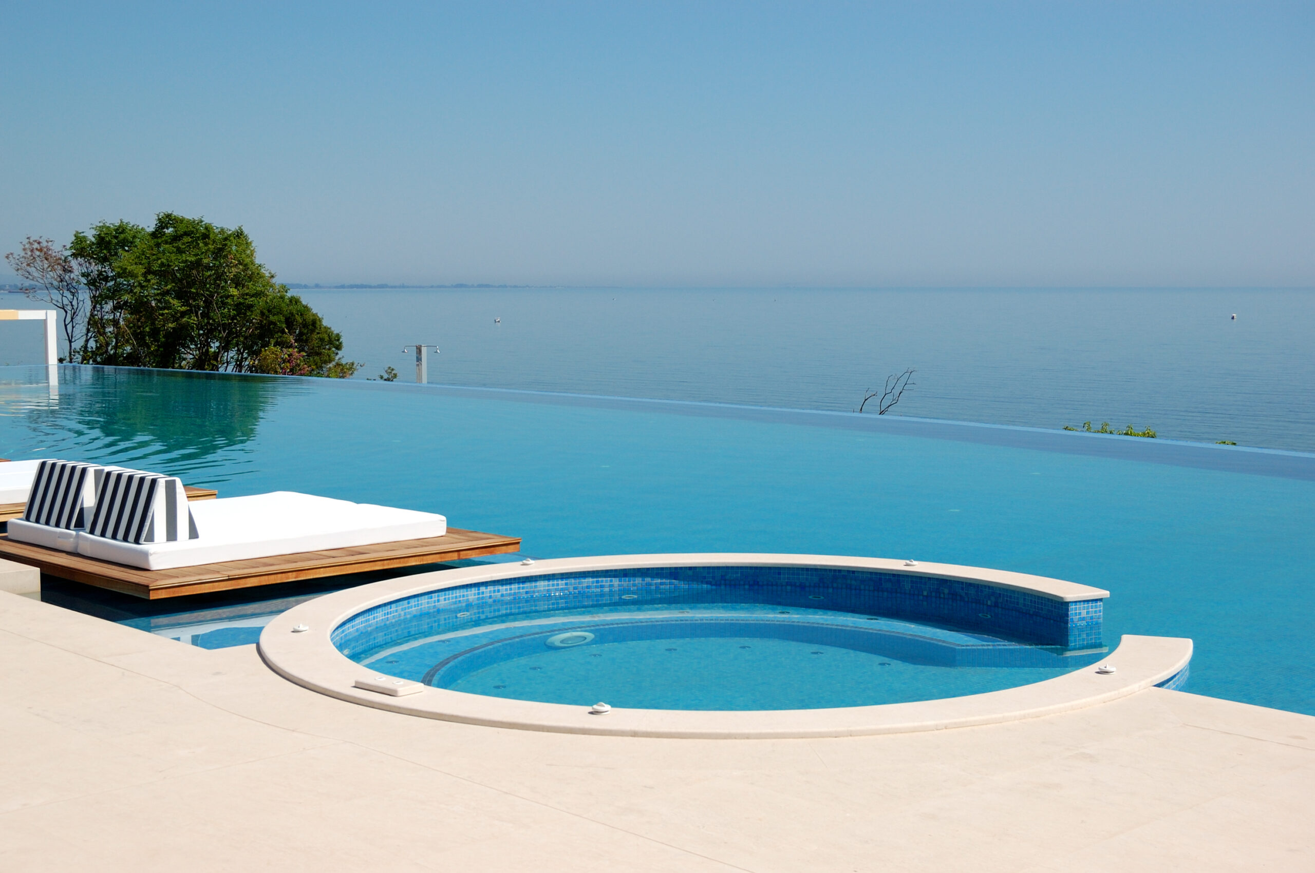 An infinity pool, also known as a vanishing-edge pool, with water seemingly extending to the horizon, creating a visually stunning and luxurious swimming experience.