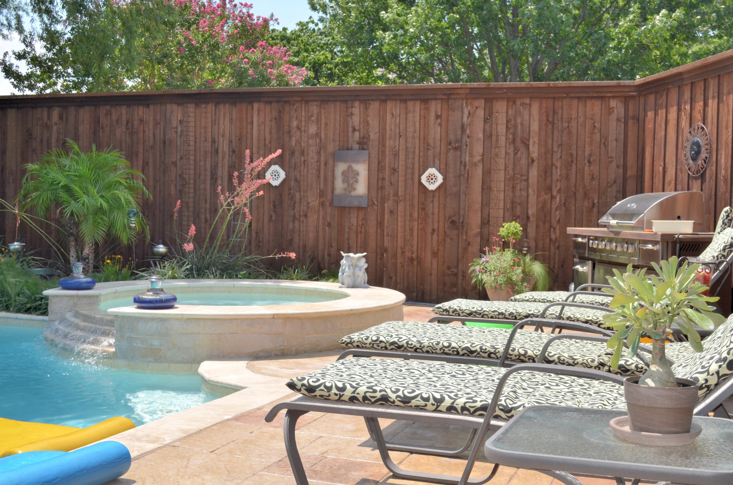 Poolside area with metal chairs featuring foam cushions