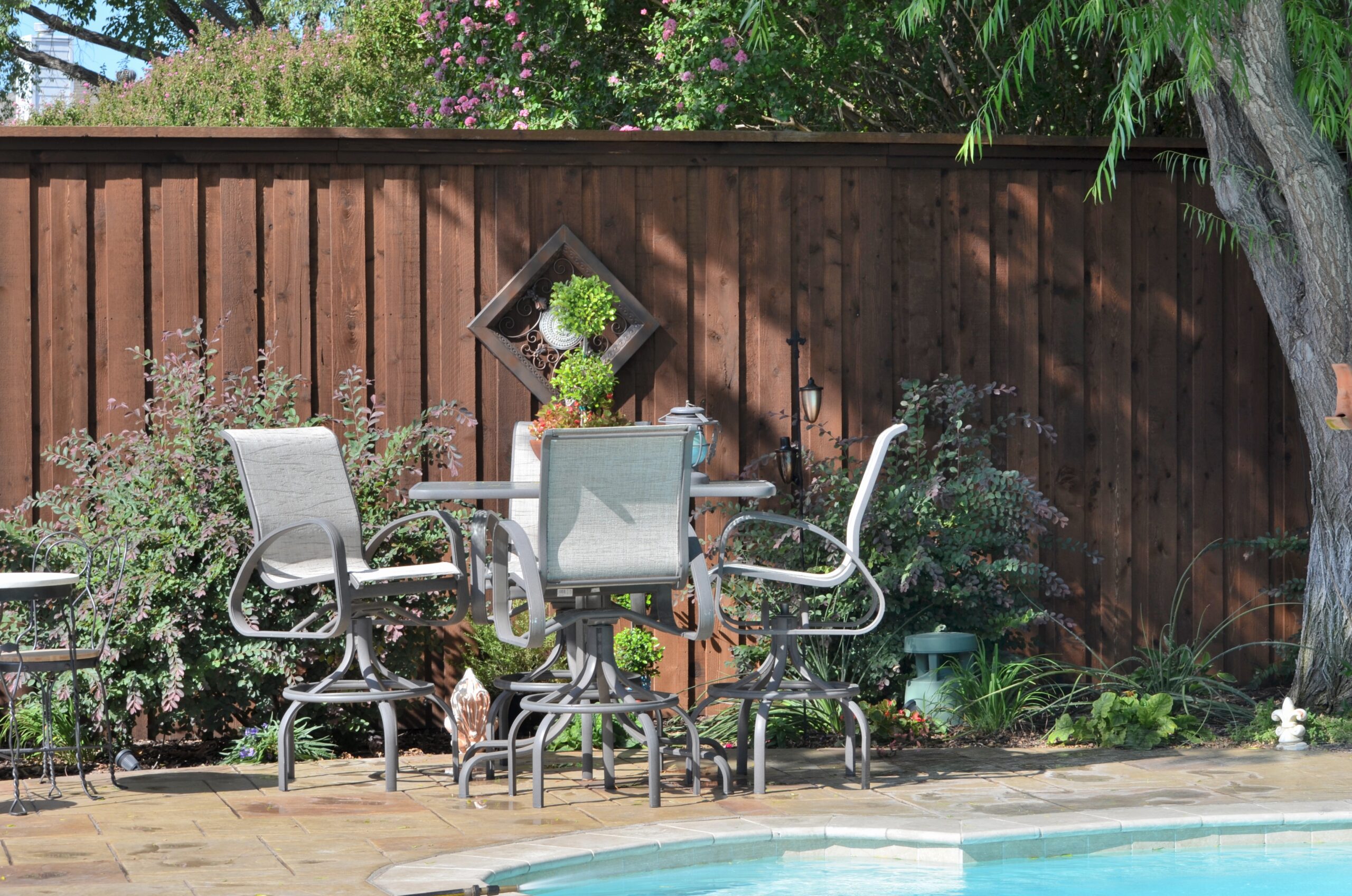 The poolside area with chairs and a table.