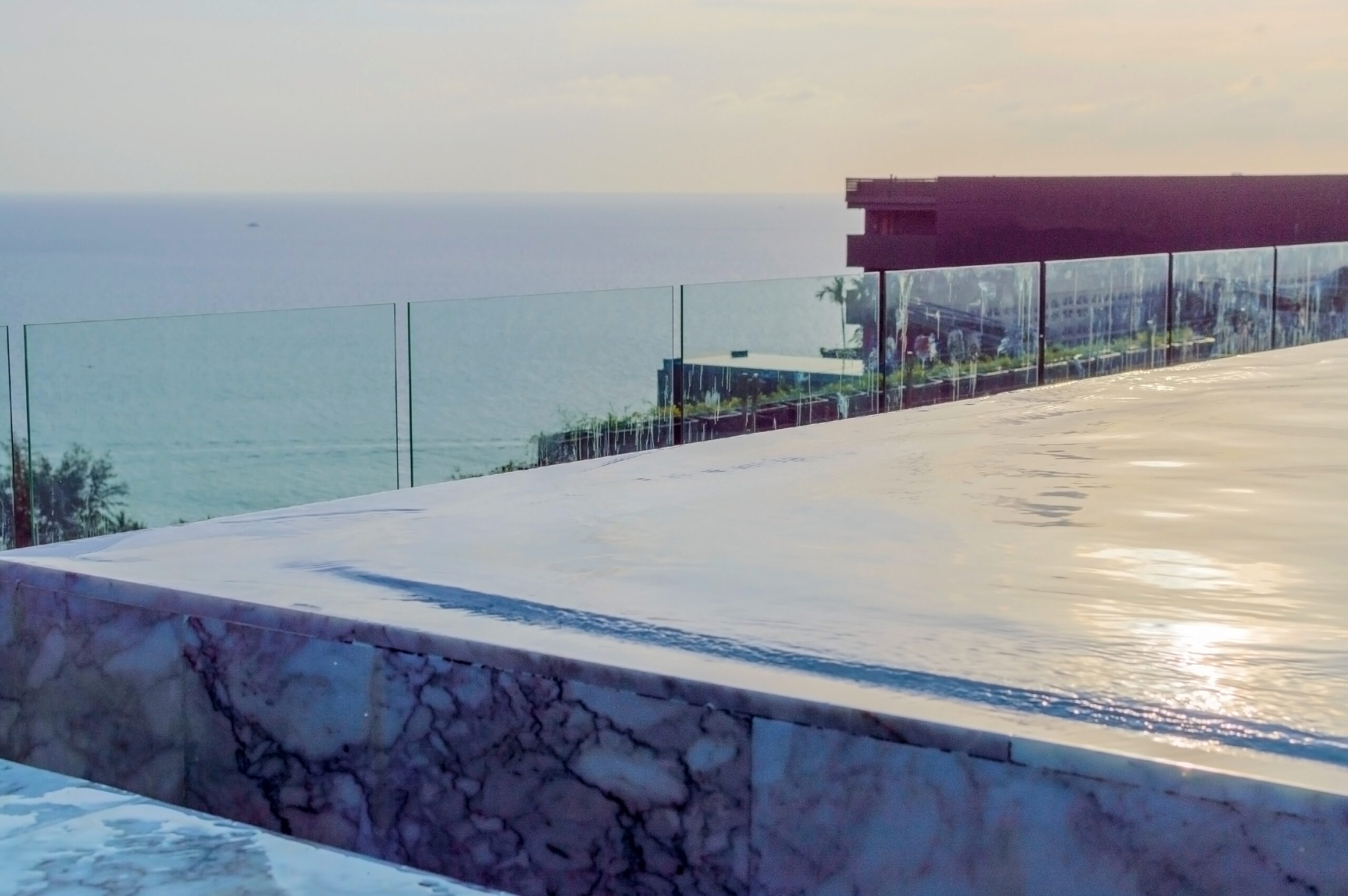 Edge of overflow swimming pool. Water cascade.