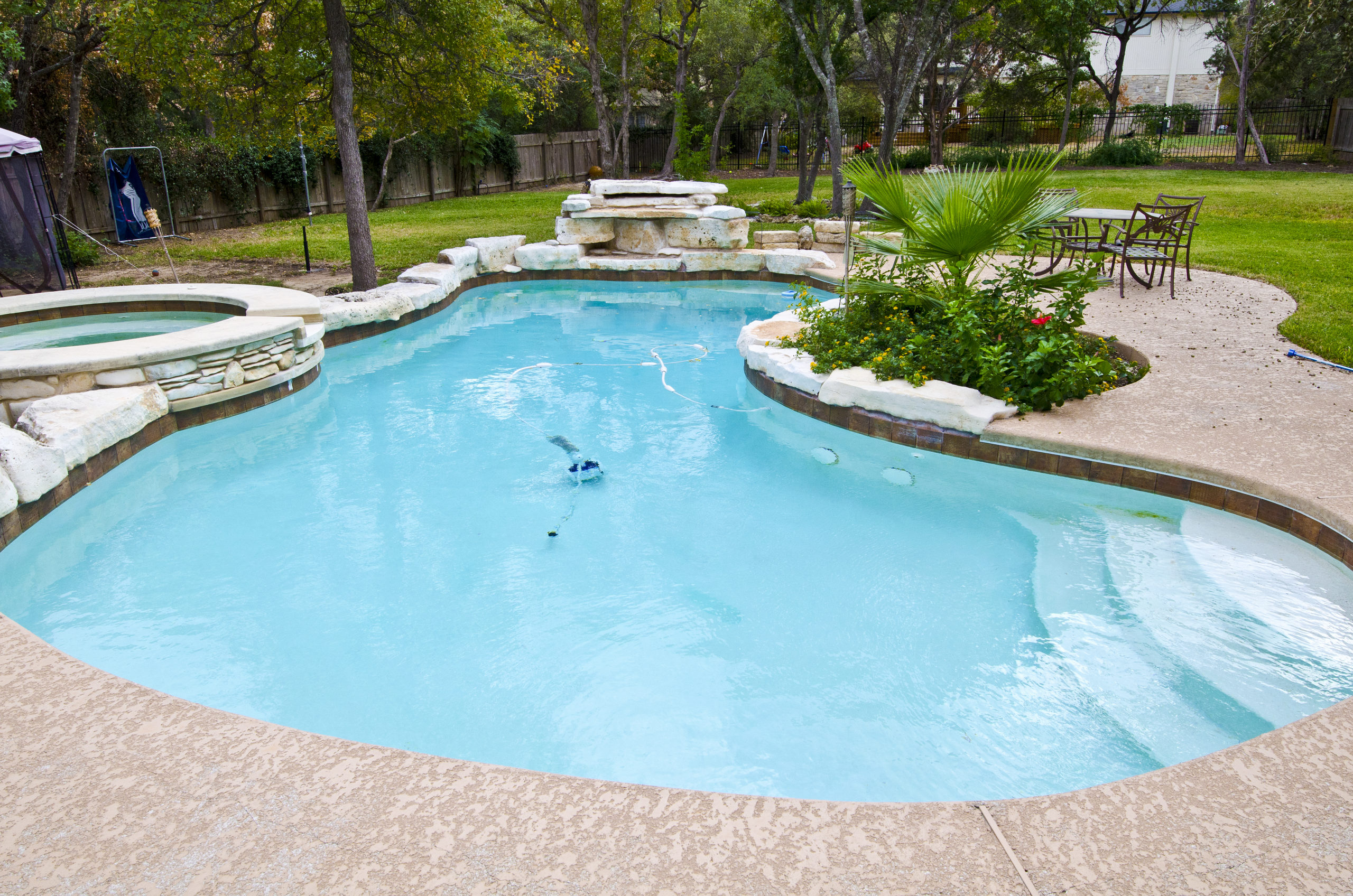 A freeform pool, showcasing a naturally shaped and irregular design, often resembling a lagoon or pond.