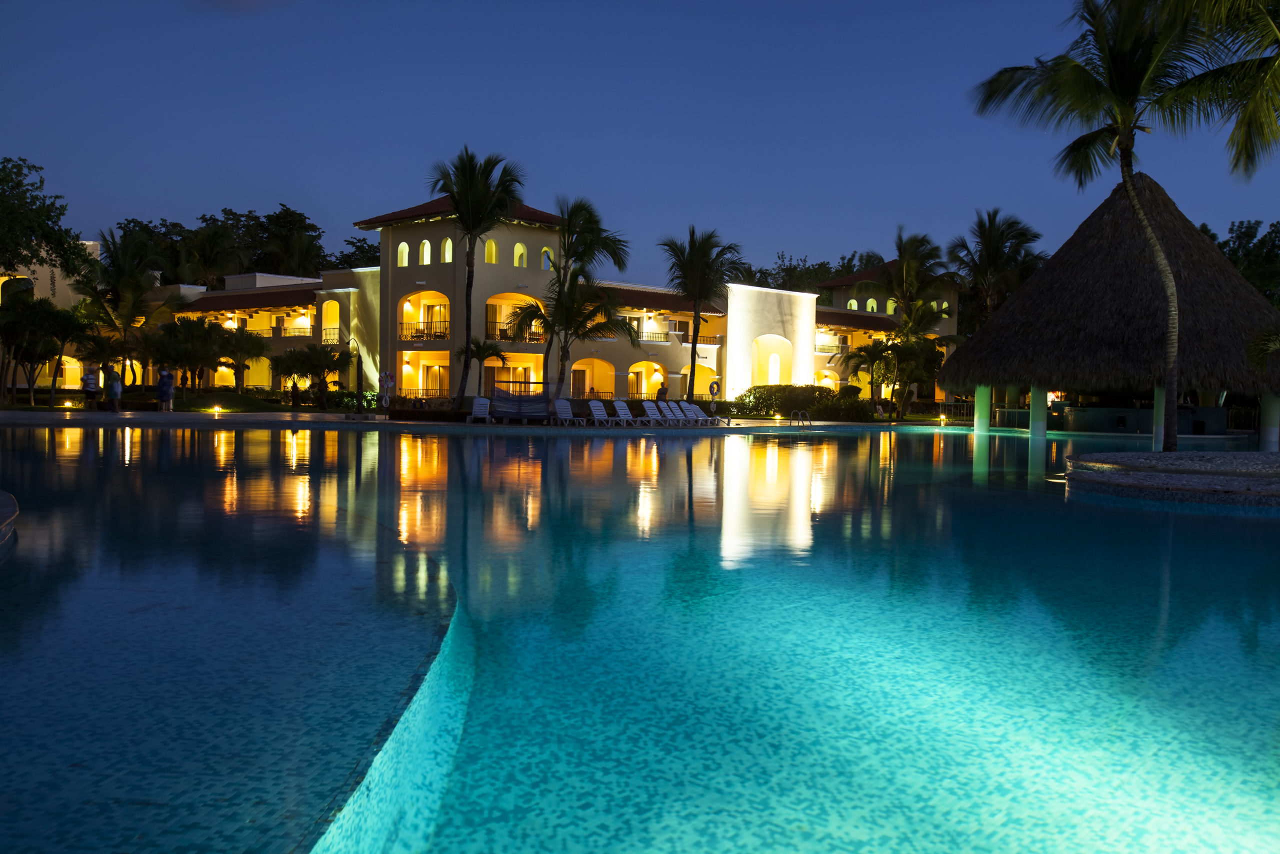 A uniquely shaped pool accentuated by a stunning array of vibrant lights, showcasing its distinctive design with a captivating play of colors and illumination.