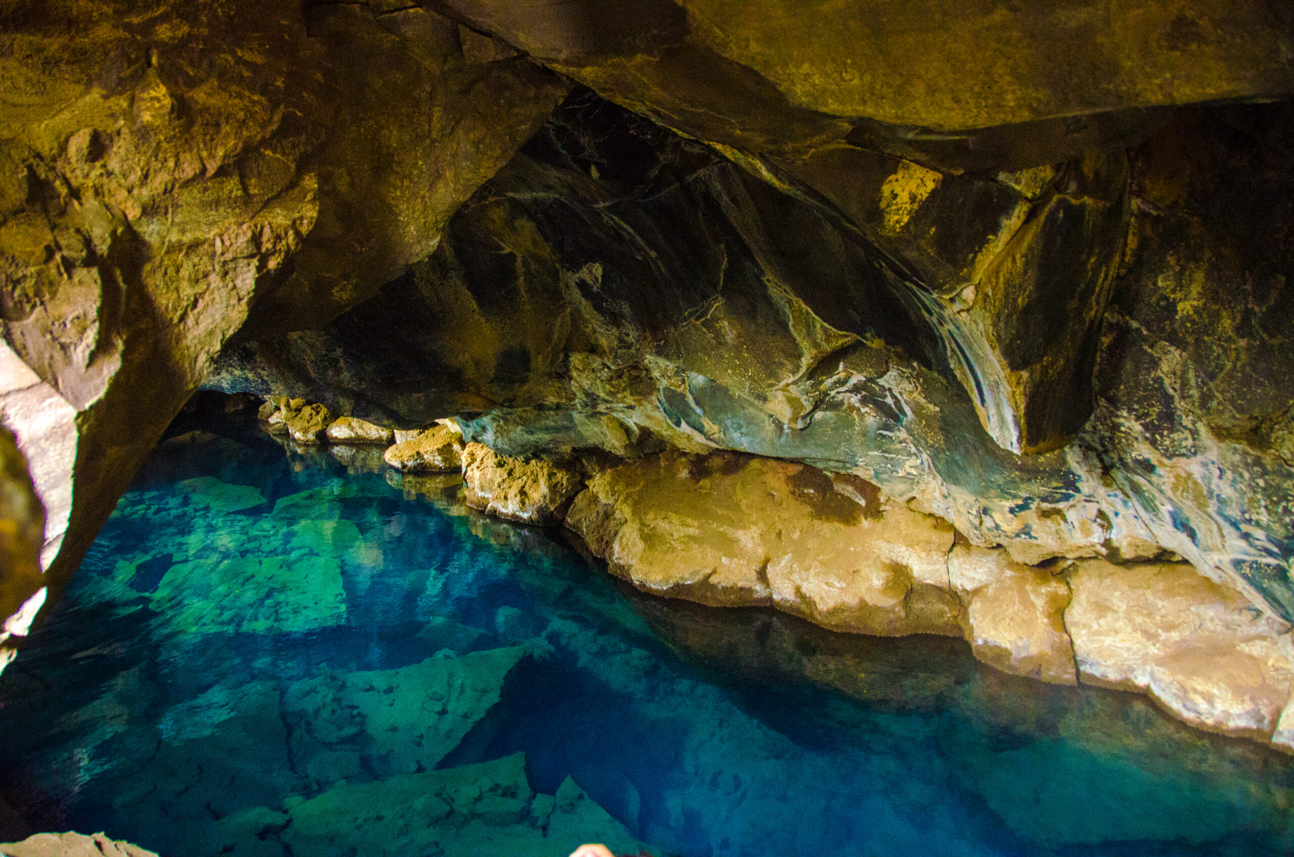 A grotto cave pool, featuring a natural or man-made cave structure integrated into the pool area