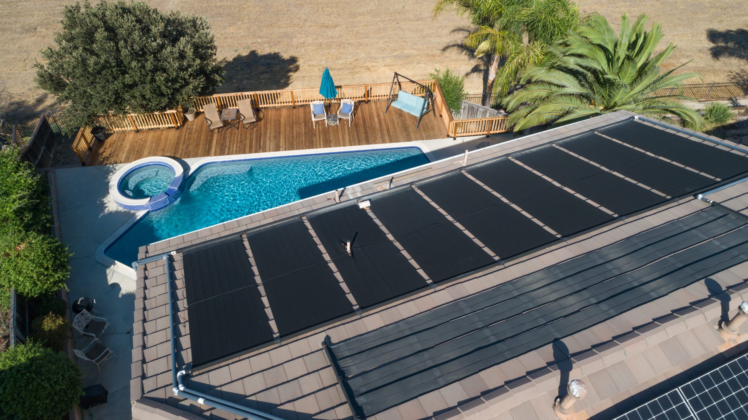 Using solar panels to harness the sun's energy for heating a pool, demonstrating an eco-friendly and sustainable approach to maintaining pool temperature.