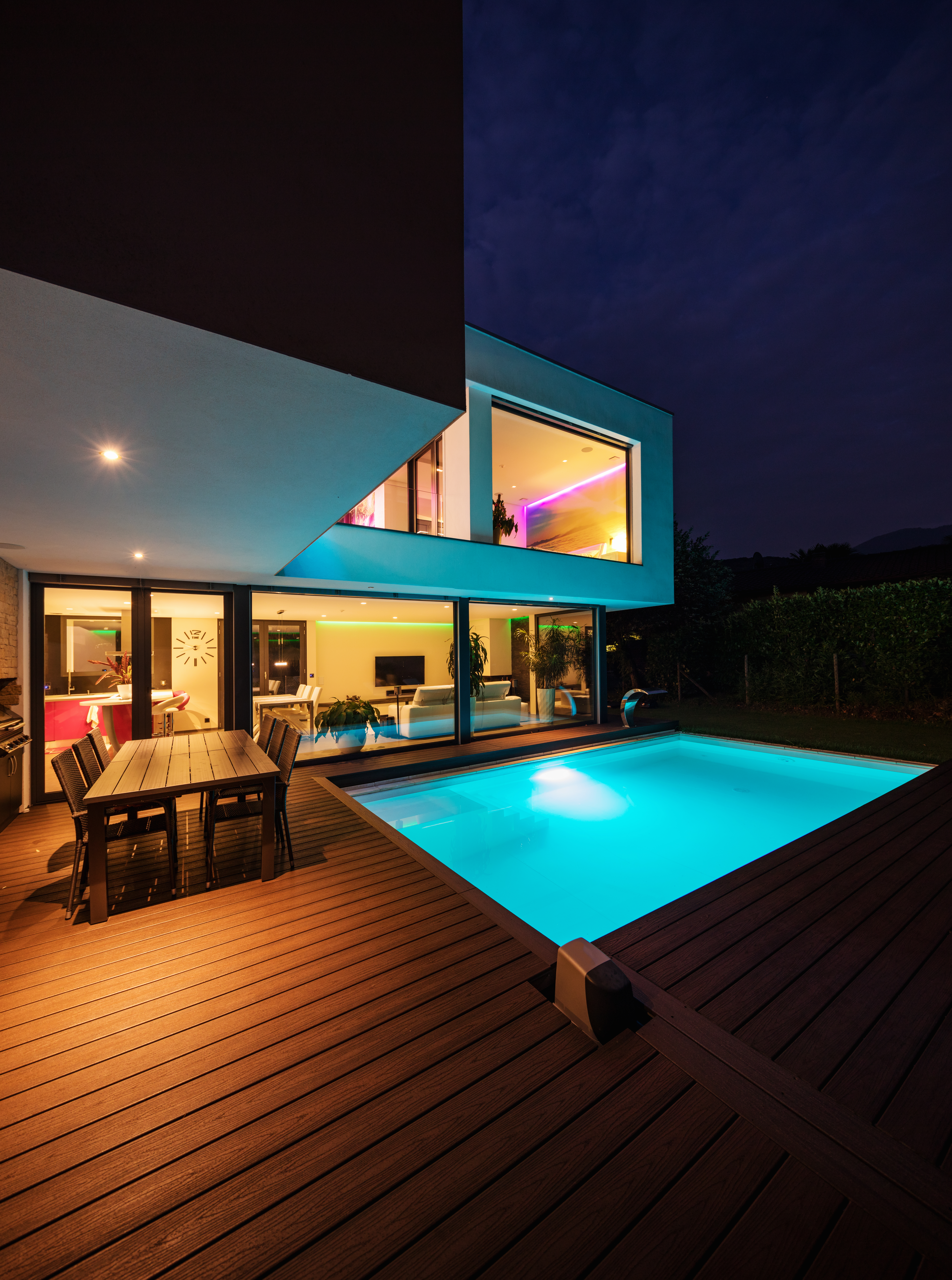 A house with a small outdoor pool, featuring underwater lighting that adds a subtle and enchanting glow to the water, creating an inviting and visually appealing atmosphere.