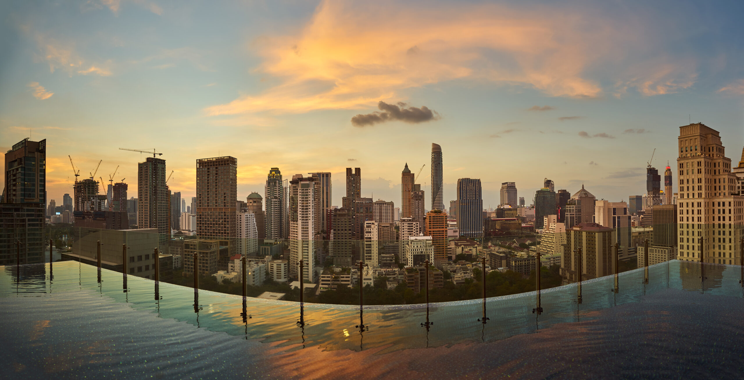 A rooftop pool surrounded by city buildings, offering a serene and elevated oasis in an urban setting