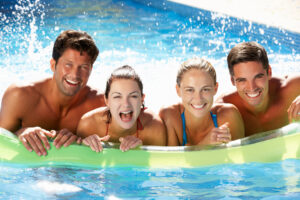 Group Of Friends Having Fun In Swimming Pool