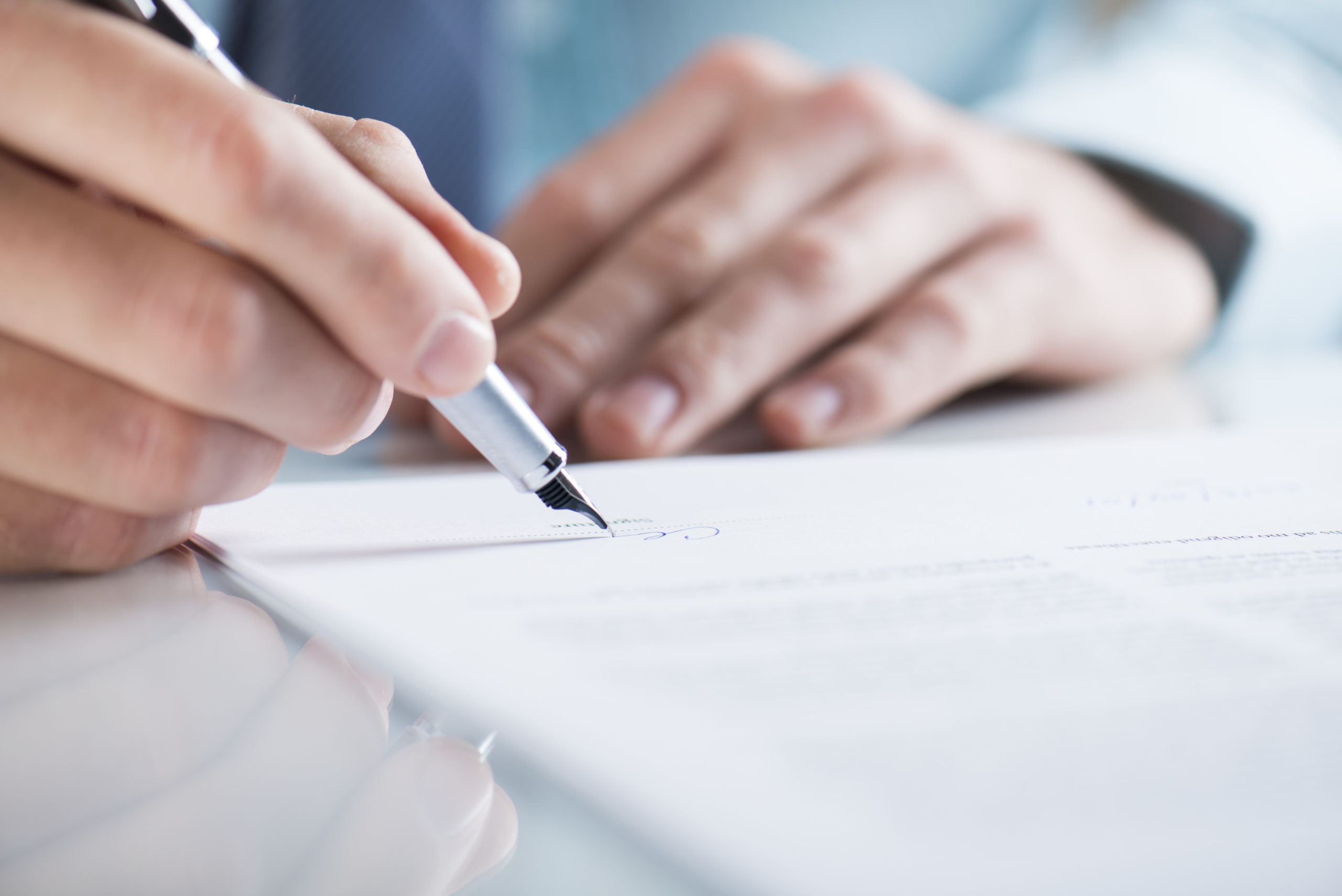 A man signing up for pool construction services, taking the first step towards building his dream swimming pool.