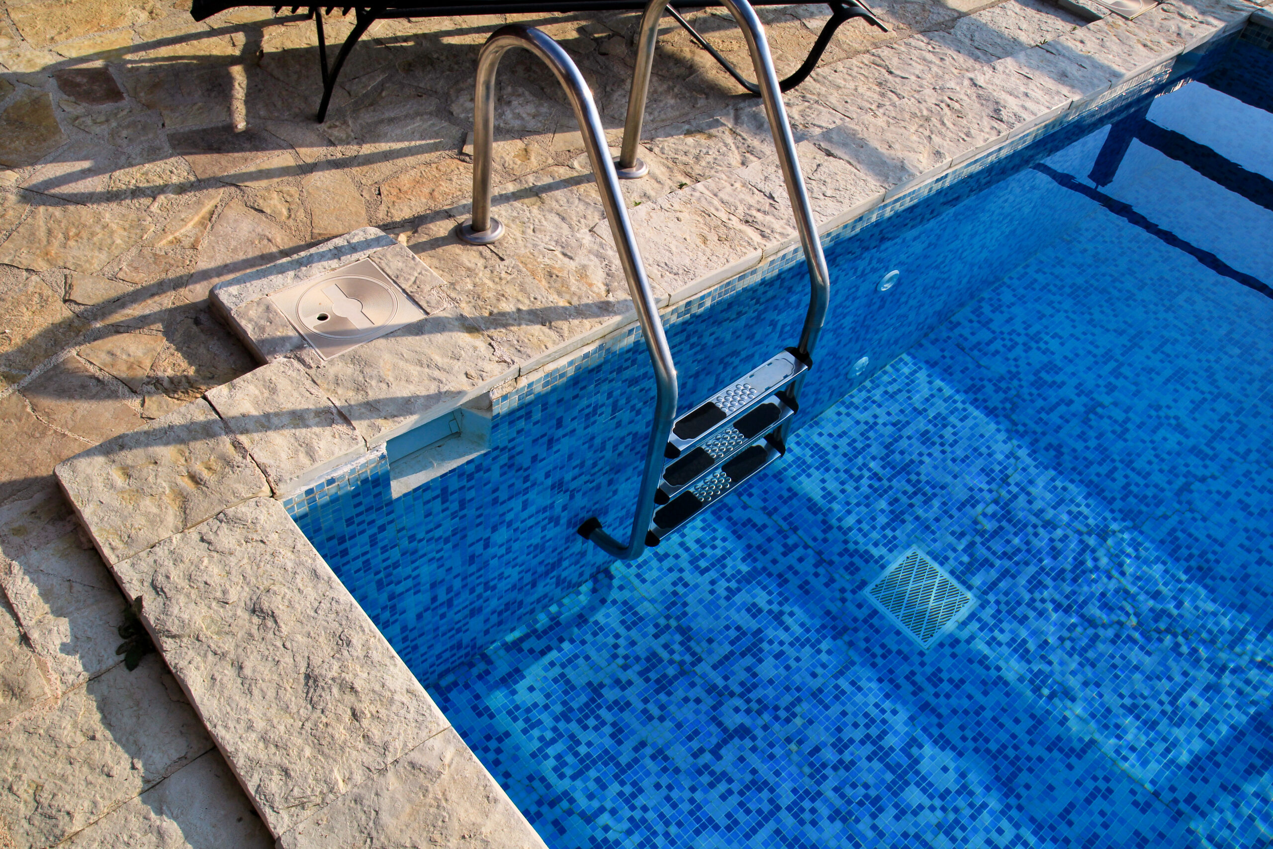 Pool rails, also known as handrails or grab rails, installed along the pool's edge or steps for safety and support when entering, exiting, or moving around the pool.