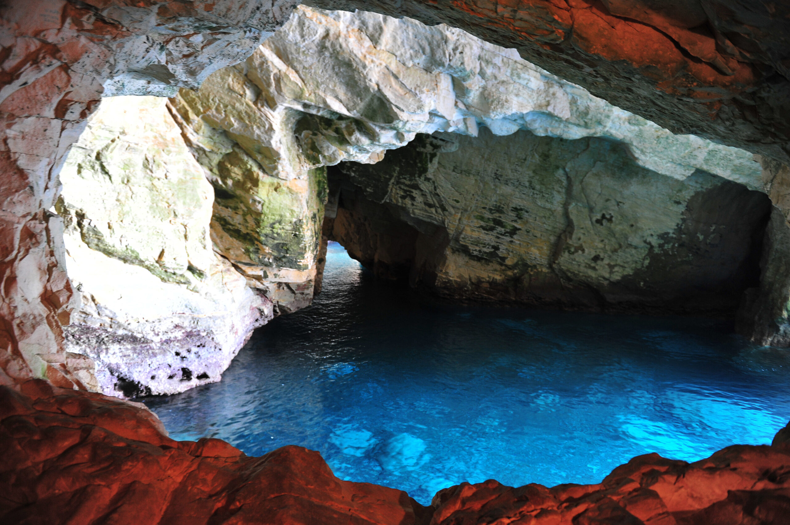 A grotto cave pool, featuring a natural or man-made cave structure integrated into the pool area