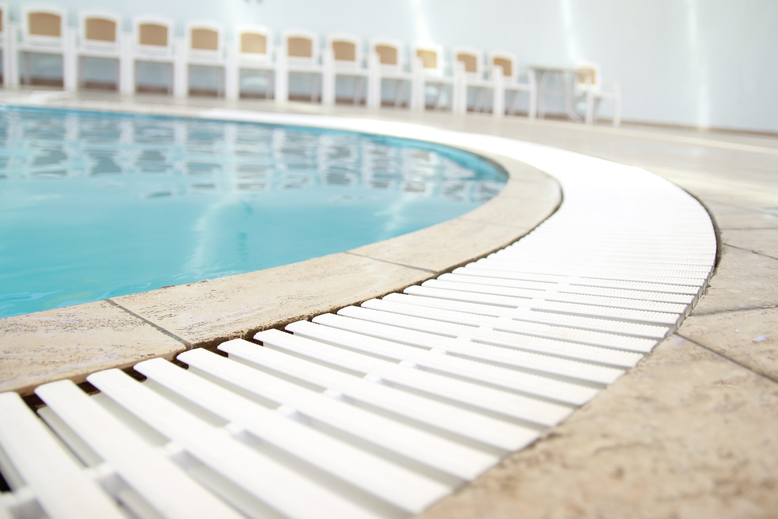 Baja steps, also known as tanning ledges, in a pool, featuring shallow, sunbathing-friendly areas with a gradual descent into the water, ideal for lounging and wading.