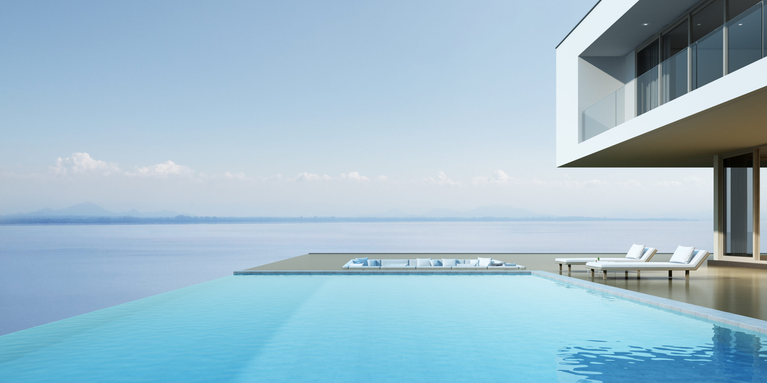 A rooftop overflow pool, positioned on top of a building, with its unique design allowing water to spill over the edges, offering a picturesque view and a sense of boundless tranquility