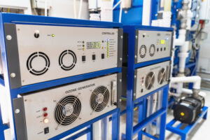 Automated ozone generator for ozonation of pure drinking water in water production factory, close up.