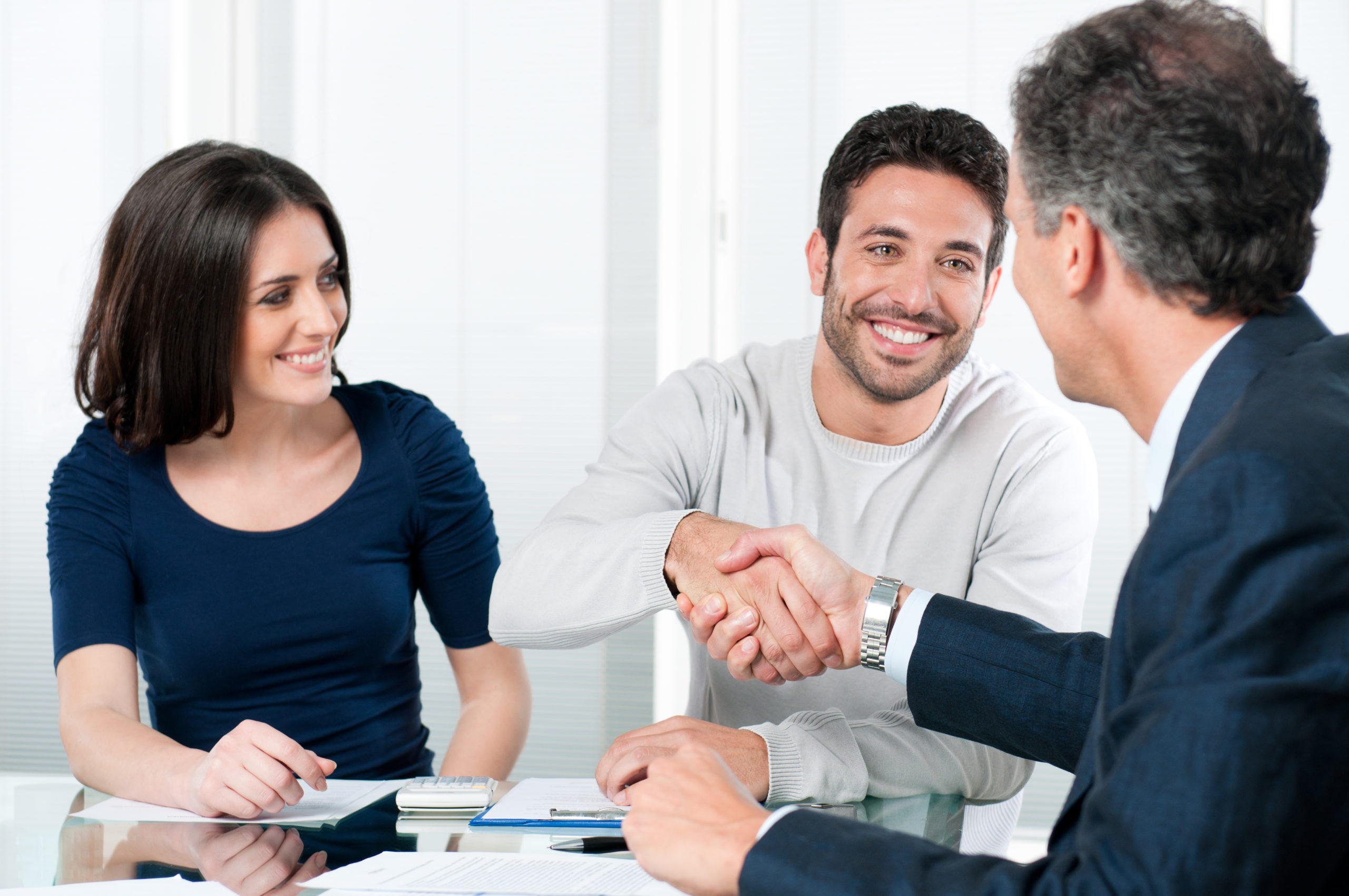 A person engaged in a negotiation with a pool contractor, discussing terms, costs, and project details to reach an agreement for the construction or renovation of a pool.