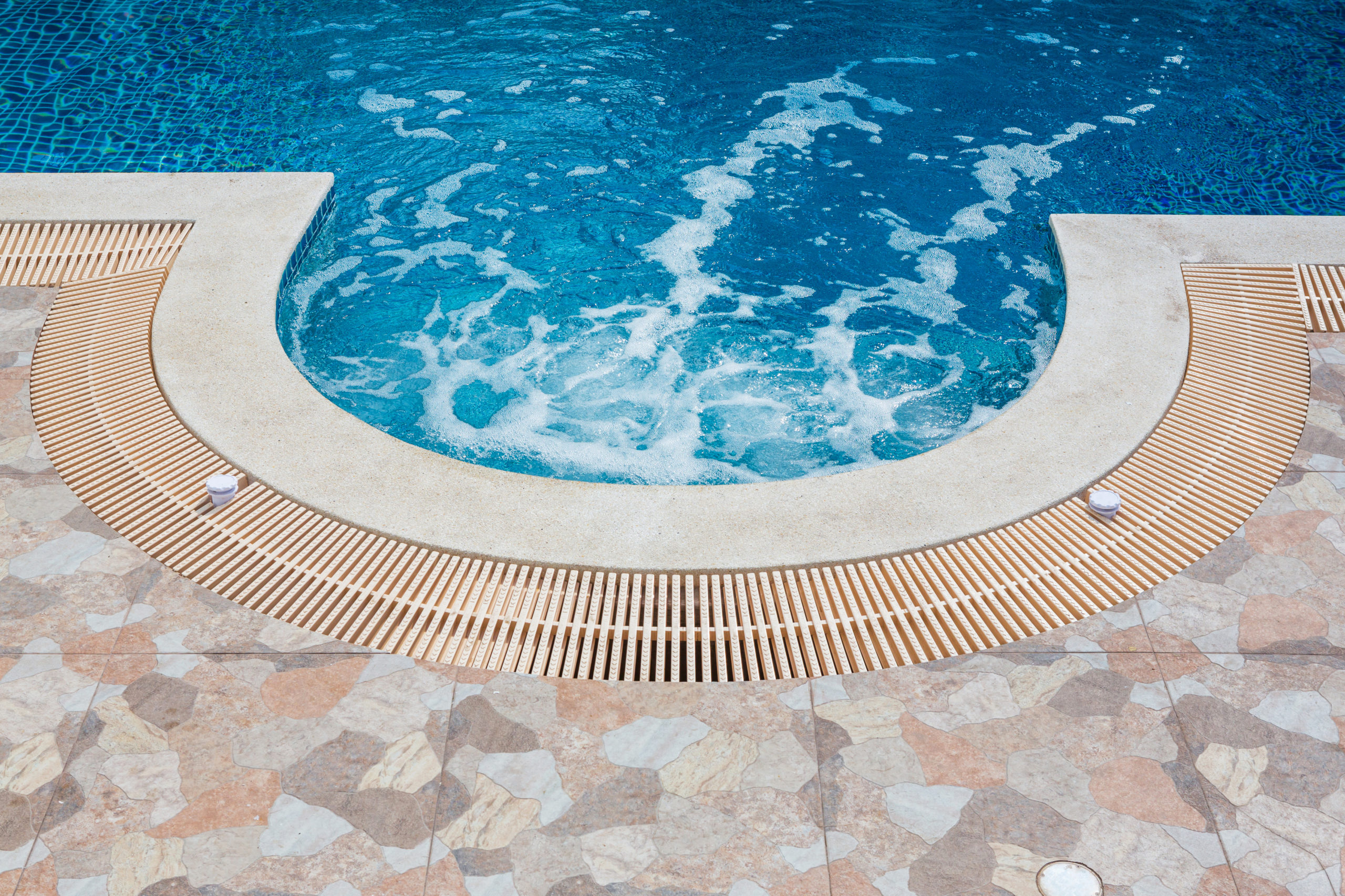 Water flow with bubbles in a pool, capturing the dynamic movement of water and the formation of bubbles, creating a visually appealing scene.