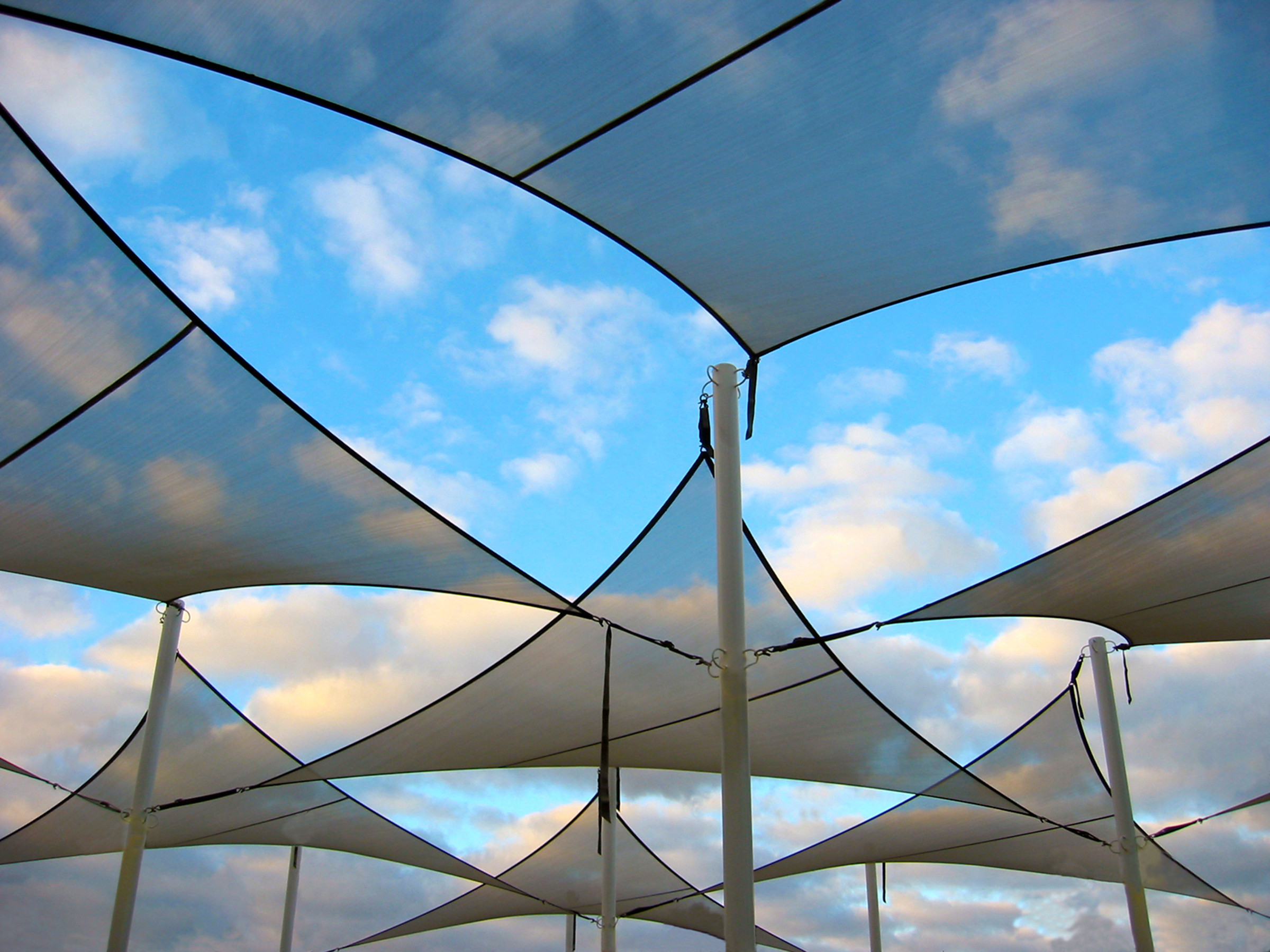 A pool umbrella, a type of sunshade typically placed poolside to provide shade and protection from the sun.