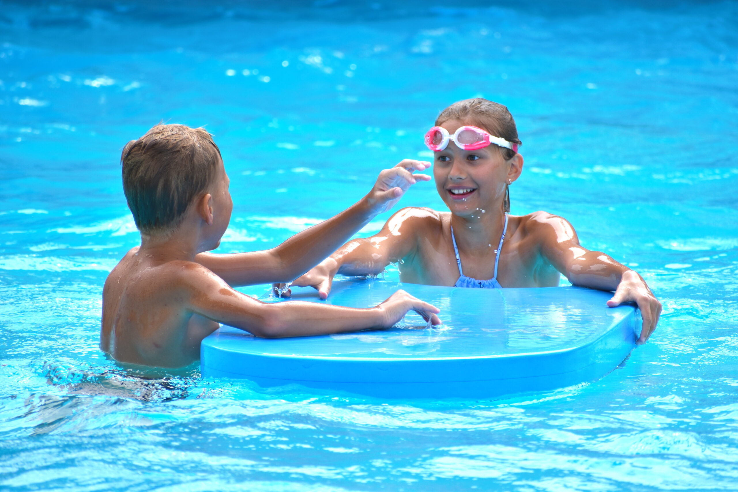 A boy and a girl engaged in a pool game