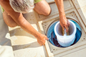 a man holding a pool filter