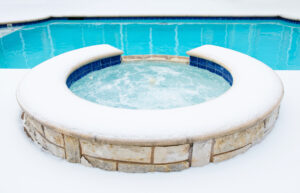 swimming pool surrounded by snow in the winter
