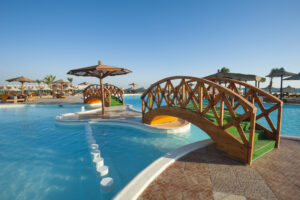 Large swimming pool with bridges at tropical summer holiday resort