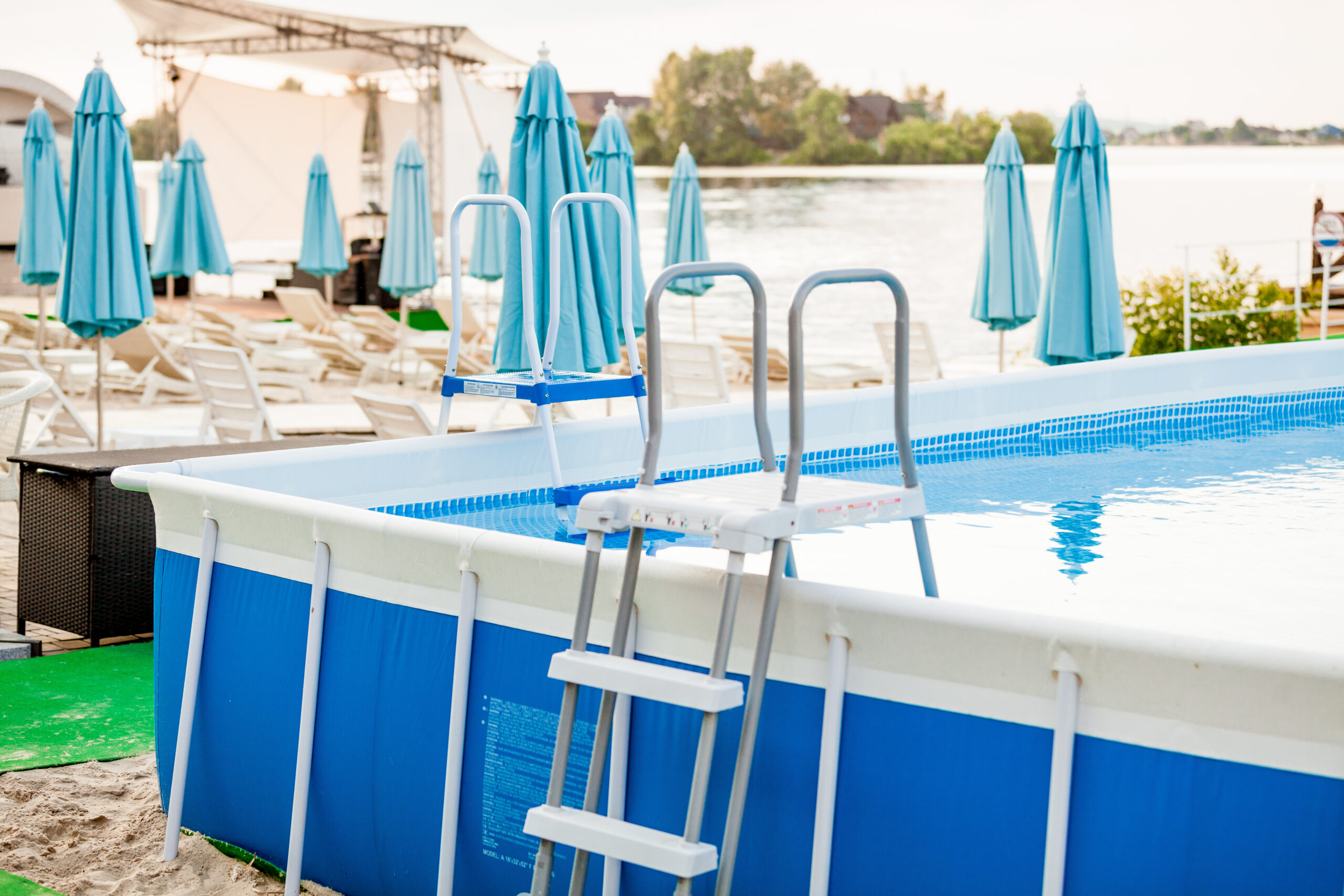 A pool in a small space with umbrellas providing shade