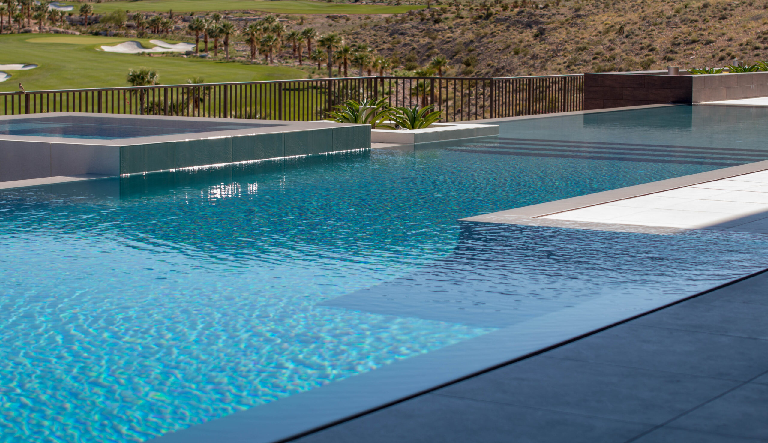 Perimeter overflow pools, also known as vanishing edge or infinity pools, feature water overflowing the edges, creating a stunning optical illusion of the water blending seamlessly with the horizon