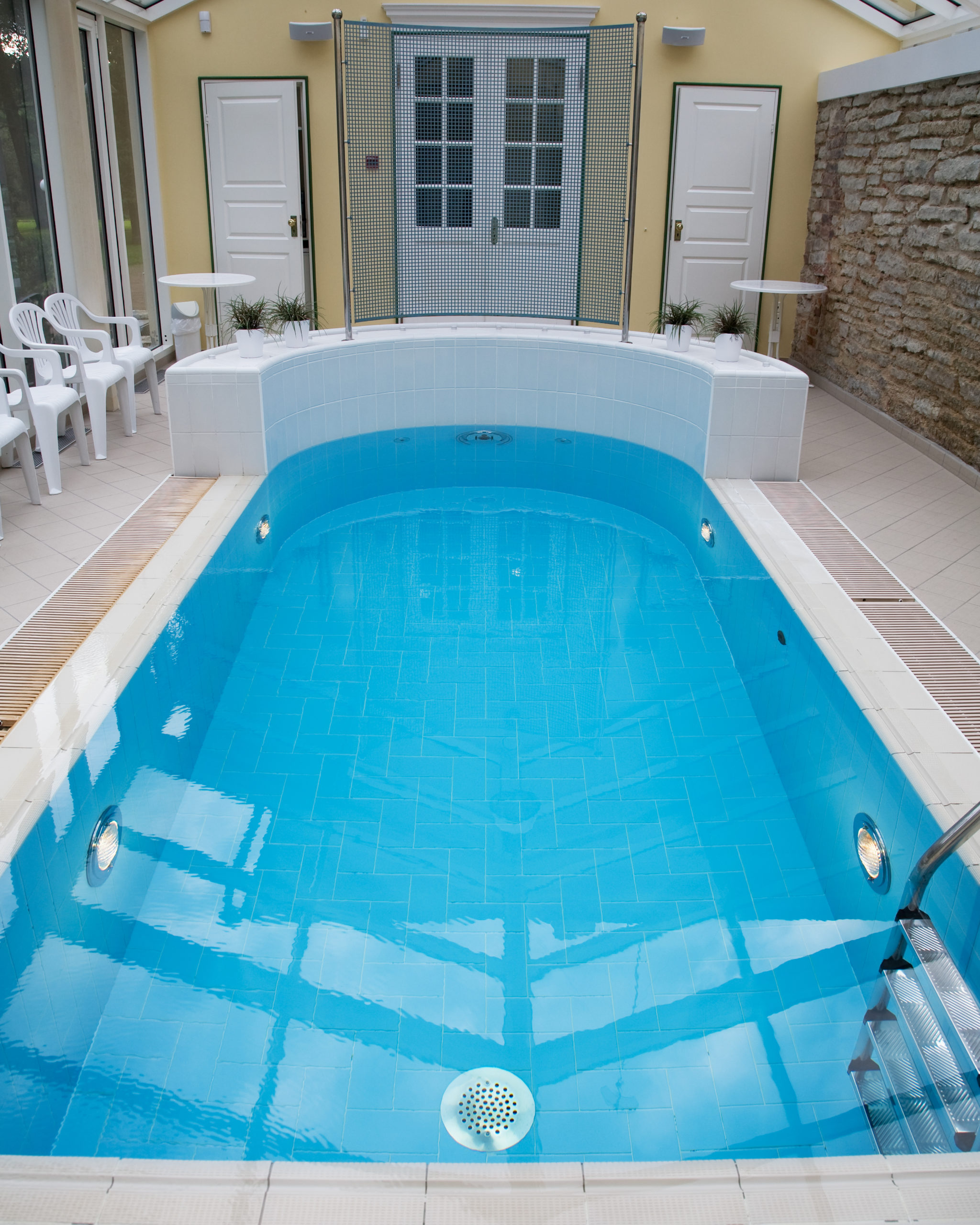 Ventilation system in an indoor pool area, ensuring proper air circulation and humidity control to maintain a comfortable and safe environment.