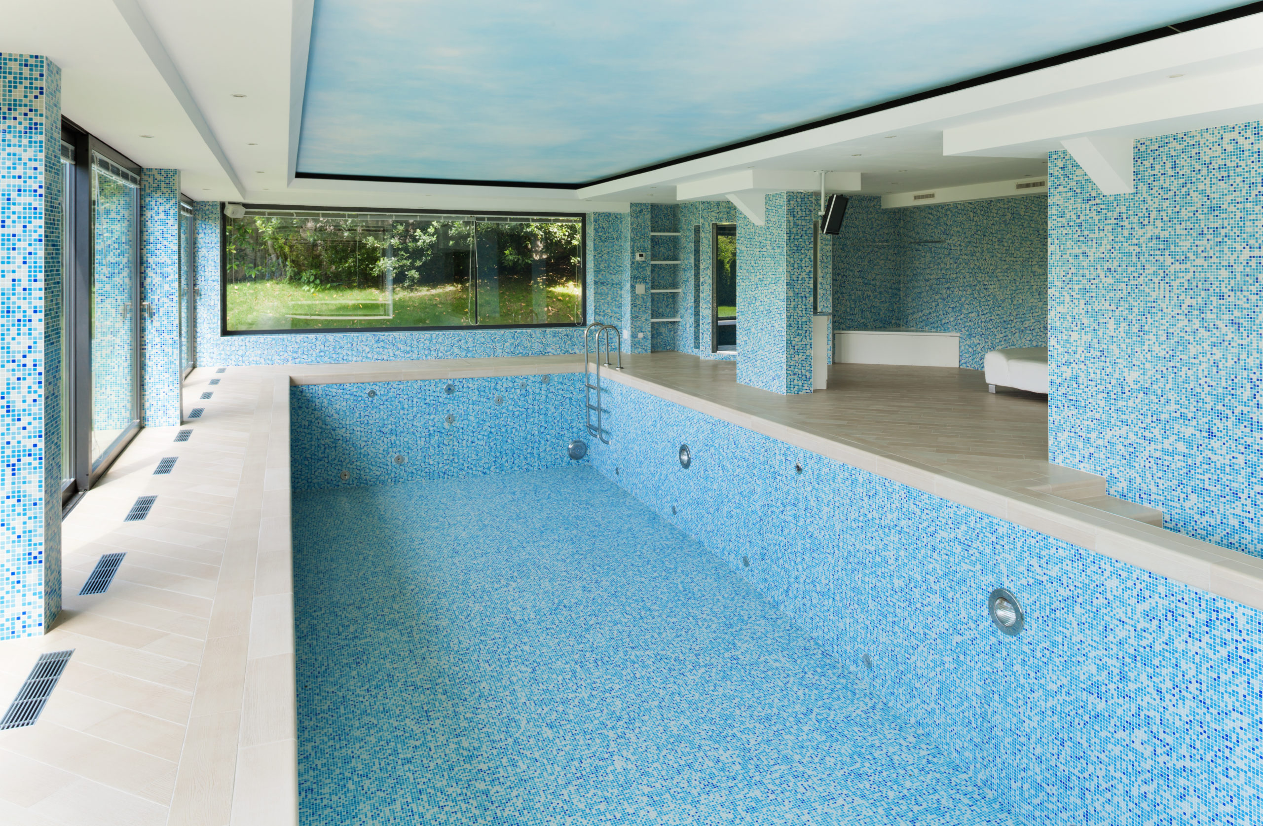 An unfinished pool interior in the process of being designed and constructed, with elements like tiles, lighting, and features yet to be completed, showing the early stages of the design and construction process.