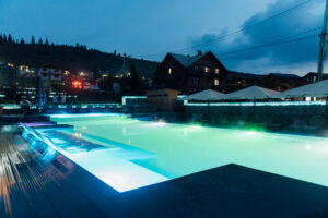 Swimming pool with multi -colored illumination at the hotel in the Carpathian mountains in Ukraine.