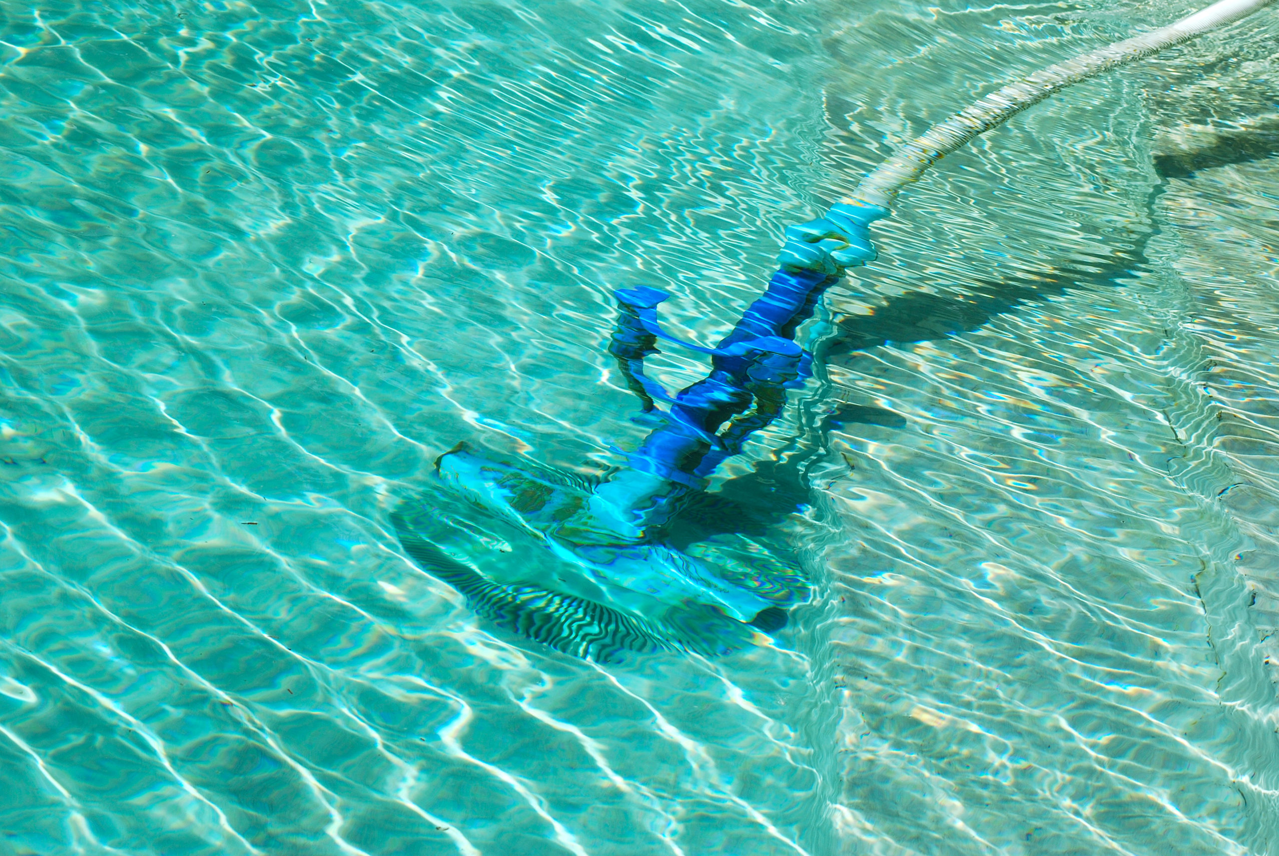 Pool cleaning in progress using an automatic brush, ensuring a thorough and efficient cleaning of the pool's surfaces.