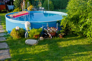 Swimming pool in a garden during the sunset time.